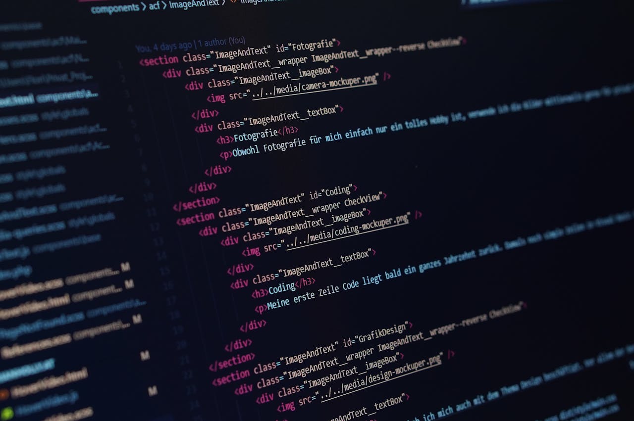 Close-up view of HTML code displayed on a dark screen, showcasing coding concepts.